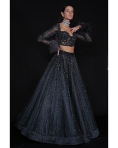 Charcoal Blue Lehenga Set - Bora Honey's Immerse yourself in the allure of our Charcoal Blue Lehenga, a mesmerizing ensemble adorned with an exquisite interplay of stones, crystals, and sequins. The meticulous craftsmanship showcases the intricate detailing of Japanese cut-dana, adding a touch of sophistication and elegance. The ethereal design is further accentuated by delicately incorporated feathers, creating a harmonious blend of tradition and contemporary style in this captivating charcoal Fitted Black Set For Gala, Fitted Black Sets For Gala, Black Fitted Sets For Gala, Fitted Party Wear Sets For Gala, Fitted Sets For Gala Party Wear, Glamorous Black Sharara For Evening, Embellished Fitted Lehenga For Gala, Blue Party Wear Sets For Evening, Glamorous Fitted Sharara For Formal Occasions