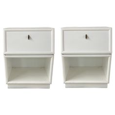 pair of white nightstands with drawers on each side