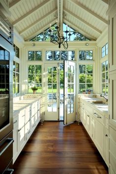 an instagramted photo of a kitchen with french doors and windows on the side