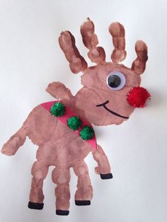 a paper plate with a reindeer on it and a red pom - pom