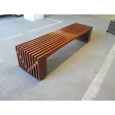 a wooden bench sitting on top of a cement floor