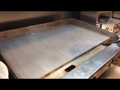 an industrial kitchen with a large metal sheet on the counter