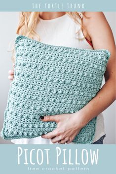 a woman holding a crocheted pillow with the text, the turtle trunk picot pillow