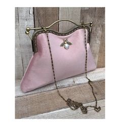 Stunning, handmade, blush pink velvet clutch bag with bee detail. The lining is made with a beautiful cotton fabric. Use it as a classic clutch or attach the shoulder strap to wear over your shoulder or as a crossbody. - Bronze colour Chain strap (detachable) - Bronze colour Kiss clasp (20.5cm) - H: 21.5cm (handle not included) x W: 29.5cm x D:5cm approximately - The pattern of the lining inside of the bag may vary. But don't worry, I always make sure the lining of the bag matches the outside be Blush Rectangular Bag For Parties, Vintage Pink Evening Bags, Velvet Clutch For Wedding, Blush Rectangular Party Bag, Rectangular Blush Party Bag, Pink Evening Pouch Shoulder Bag, Feminine Pink Clutch Evening Bag, Velvet Evening Clutch Bag, Elegant Velvet Clutch Bag