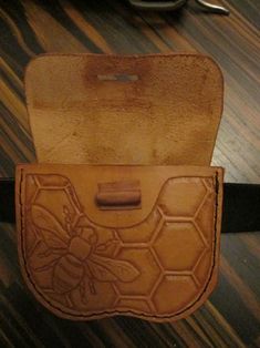 a leather case with a bee on it