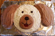 a cake shaped like a dog with icing on it