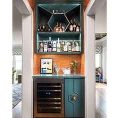 an open cabinet with bottles and glasses on it