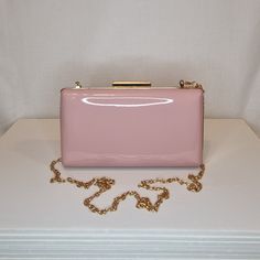 Womens blush pink patent evening clutch bag with gold embellishment and top closing clasp (please note: bag is full all over patent finish and any patterns are only reflections) Can be used with or without long shoulder chain (included) size approx- H 10.5cm x W 18.5cm Optional Dust Bag: White lightweight soft polyester portable travel dust bag pouch, suitable for protecting items from dust, dirt, hairs and scratches when not in use size approx- L 47cm x W 31.5cm Material: 100% polyester Please Gold Embellishment, Shoulder Chain, Pink Blush, Evening Clutch Bag, Portable Travel, Evening Clutch, White Bag, Clutch Handbag, Evening Bags