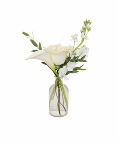 a vase filled with white flowers and greenery