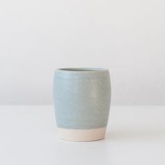 a blue and white cup sitting on top of a table