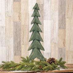 a green christmas tree sitting on top of a mantle