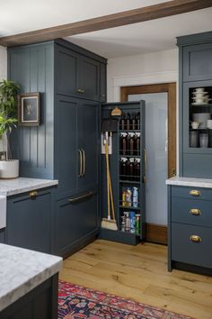 a kitchen with blue cabinets and white counter tops