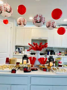 a kitchen counter topped with lots of food and decorations on it's side table