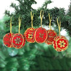 four ornaments hanging from a christmas tree