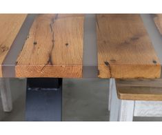 a wooden table with metal legs and wood planks on the top is shown in this image