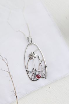 ITEM DESCRIPTION: The size H 4 cm x W 3 cm (1 3/4 x 1 inch). Weight - 6 g. You can buy it with the chain or without. The most delicate flower of the lotus can make someone very happy. I made this floral jewelry of sterling silver, rhodolite garnet, and moonstone. This is a true work of art. It will emphasize your exquisite taste and status, and will also bring a lot of compliments. Lotus flower earrings https://www.etsy.com/listing/676137548/lotus-flower-earrings-sterling-silver?ref=shop_home_ac Elegant Oval Pendant Necklace With Soldered Details, Silver Wire Wrapped Flower Jewelry, Customizable Silver Flower Pendant Jewelry, Hand Forged Flower Pendant Necklace As Gift, Wire Wrapped Flower Pendant Jewelry Gift, Flower Shaped Hand Forged Jewelry Gift, Hand Forged Flower Jewelry Gift, Hand Forged Flower Shaped Jewelry Gift, Unique Silver Flower Pendant Necklace