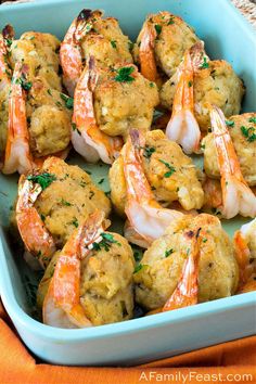 cooked shrimp in a blue dish on an orange towel