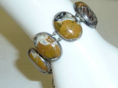 Vintage, early JOSEFF of HOLLYWOOD bracelet.  A rare find, and highly collectible. This striking bracelet features a sterling silver link setting with 8 large, caramel, cream, black and mahogany natural Agate stone cabochons.  Excellent vintage condition.  NO chips or cracks to the stones.  Hidden clasp closure is in good working order.  Safety chain. Eugene Joseff began producing jewelry in Hollywood California in the 1930's.   He sold, and rented out 90% of the jewelry seen in the old Hollywoo Collectible Silver Bracelets With Natural Stones, Vintage Agate Bracelet Jewelry, Vintage Agate Bracelets With Natural Stones, Vintage Agate Bracelet, Vintage Agate Oval Cabochon Jewelry, Vintage Sterling Silver Bracelet With Natural Stones, Vintage Sterling Silver Bracelets With Natural Stones, I Love Lucy Episodes, Katherine Hepburn