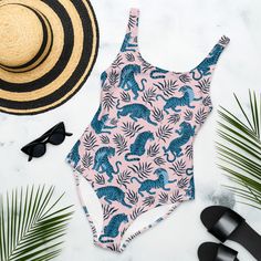 This one-piece swimsuit for all figures will bring out your best features. Enjoy the smooth fabric and the flattering design, and show it off by the sea or pool! * 82% Polyester, 18% Spandex * Fabric weight: 6.78 oz/yd² (230 g/m weight may vary by 5% * Chlorine-resistant fabric * Cheeky fit with a scoop neckline and a low scoop back * Zig-zag stitching * Double-layer front  * Four-way stretch material stretches and recovers on the cross and lengthwise grains Tropical Print Tropical Style Bodysuit For Pool, Tropical Print Bodysuit For Pool, Stretch Tropical One-piece Swimsuit For Pool, Tropical Stretch One-piece Swimsuit For Pool, Tropical Stretch One Piece For Pool, Printed Tropical Swimwear For Pool, Tropical Printed Swimwear For Pool, Tropical Printed Bodysuit For Swimming, Tropical Printed Bodysuit For Beach