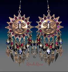 "These Celestial Boho Chandelier Earrings are made with large hand-antiqued brass Sun stampings richly decorated with crystal rhinestone 3'rd eyes and rays. Amethyst & Garnet Red crystal and glass beads and metal diamoond charms add to the whimsical design. Available in Posts, Clip-Ons or French Wires. -3 1/4\" Long(not including piercing) x 1 3/4\" Wide -0.3 oz. ea. *Comes Ready To Gift in Decorative Packaging *Each Pair is Made Just for You! Kerala Rose Pinterest page: https://www.pinteres Bohemian Sun Design Adjustable Earrings, Bohemian Sun And Moon Earrings For Festivals, Bohemian Sun And Moon Design Earrings For Festival, Bohemian Sun Design Earrings For Festival, Red Bohemian Jeweled Jewelry, Bohemian Red Jeweled Jewelry, Suns With Faces, Victorian Chandelier, Celestial Boho