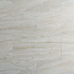 a white marble tile wall that looks like it has been polished