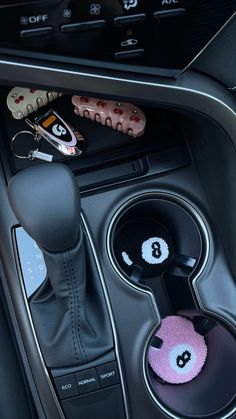 the interior of a car with buttons and steering wheel knobs on it's center console