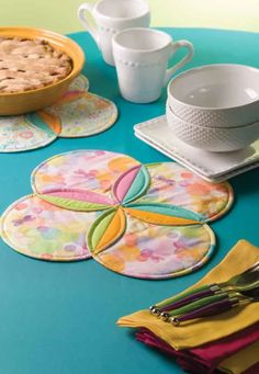 the table is set with place mats, napkins, and pie dishcloths