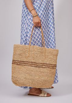 Our classic Luxe Striped Tote with black stripes is sure to brighten up your spring and summer! Packable for easy travel and roomie for all of your goodies. Optional leather loop to hold your favorite sunhat! Shop Black Material: 100% Raffia Straw, Handles- 100% Leather Measurements: 19" x 14"; Handle Drop- 9" Spot Cle Everyday Striped Straw Bag, Striped Woven Straw Bag, Casual Striped Straw Bag, Casual Striped Woven Straw Bag, Striped Travel Bags For Summer, Casual Striped Rectangular Straw Bag, Brown Spring Beach Bag For Travel, Spring Brown Beach Bag For Travel, Striped Beach Bag With Braided Handles