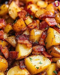 cooked potatoes with bacon and parsley in a skillet, ready to be eaten