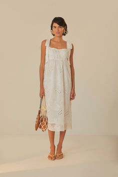 Embrace the soft allure of the Off-White Midi Dress from FARM Rio. This enchanting piece features feminine eyelet embroidery that dances across a delicate off-white fabric. With its square neckline and charming ruffle-trimmed straps, this dress exudes a romantic touch. The relaxed silhouette falls gracefully to mid-calf, and the lovely bow detailing at the back ensures a sweet exit. Perfect for sunny days or moonlit strolls, it’s a dress that whispers of daydreams and gentle elegance. Composition 65% COTTON 30% LYOCELL 5% POLYESTERCare Instructions HAND WASH SEPARATELY, DO NOT BLEACH. DO NOT TUMBLE DRY, LINE DRYING, IRON AT LOW HEAT, DO NOT DRY CLEANSize and Fit Inches XXS XS S M L XL Bust 30 32 33 3/4 35 3/4 39 42 1/4 Waist N/A N/A N/A N/A N/A N/A Length 38 1/4 39 39 2/4 40 1/4 41 41 2/4 Minimal Wedding Dress, Eyelet Embroidery, Minimal Wedding, White Midi, English Rose, Rose Embroidery, Farm Rio, White Midi Dress, Embroidery Dress