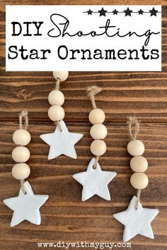 diy shooting star ornaments made from wood beads and string on a wooden table with text overlay that says diy shooting star ornaments