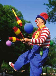 a clown juggling balls in the air