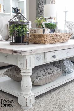 a white coffee table with baskets on top