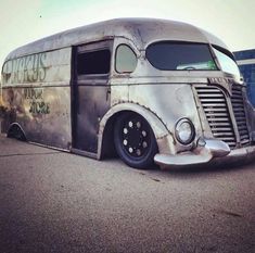 an old bus is parked on the side of the road