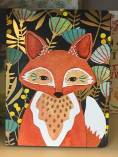 a notebook with an image of a fox on the front, and leaves in the background