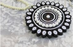 a black and white necklace with pearls on it