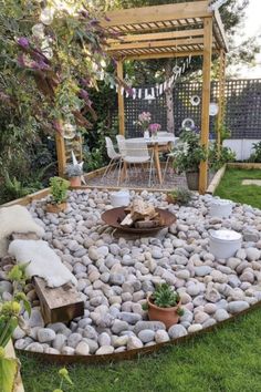 a garden with rocks and plants in the center, surrounded by a wooden pergoline