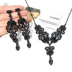 "Gothic black bridal jewelry featuring Victorian wedding Regency vintage stylec chandelier earrings and whimsigoth steampunk statement necklace with ornate damask curls and lace details made of rhinestone crystals in black plating. You may choose earrings only, necklace only or earrings necklace set. Earrings are about 3 3/8\" (8.5cm) long with posts. Necklace total length measures about 17.5\" (44cm). View matching pieces or similar designs at https://etsy.me/3E2xA1t View all Victorian inspired Black Wedding Necklace, Victorian Dangle Chandelier Earrings For Parties, Victorian Chandelier Dangle Earrings For Party, Victorian Style Party Chandelier Earrings, Elegant Black Jewelry Set For Wedding, Black Victorian Jewelry For Wedding, Victorian Black Wedding Jewelry, Black Victorian Wedding Jewelry, Gothic Dangle Jewelry For Party