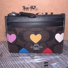 *** Coach Mini Skinny Id Case *** Signature Coated Canvas/Smooth Leather *** Multicolor Hearts *** 2 Card Slots *** Id Window *** Zip Top Closure, Fabric Lined *** Attached Split Key Ring *** 4 1/4”(L) X 3”(H) X 1/2”(W) *** Style Cp466 *** Coach Zip Card Case, Cheap Heart-shaped Women's Wallets, Black Coach Wallet With Detachable Strap, Cheap Heart-shaped Wallets With Card Slots, Coach Wallet With Zipper Closure For On-the-go, Heart Motif, Zip Top, Coach Bags, Smooth Leather