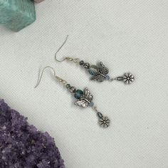 "This unique pair of earrings  is part of my FLUTTER DREAM Collection of jewelry, created in 2023 ~  This collection features themes of flight and fantasy such as butterflies, fairies, dragonflies, & wings, and has a vivid colour story of blue, green, purple, chromatics, iridescence, silver & a touch of gold.  Any or all of the pieces in the entire collection were created to be worn together: Mix and match and have some fun!  Many lovely & unique combinations are possible. Create your own set by Blue Drop Earrings With Dangling Charms, Butterfly Dangle Earrings, Colour Story, Positive Vibes Only, Touch Of Gold, Earrings Drop, Butterfly Charm, Everyday Earrings, Dragonflies