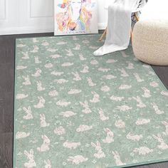 a green rug with rabbits on it in front of a white wall and flooring