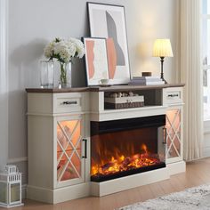 a living room with a fireplace and pictures on the wall next to it's mantle