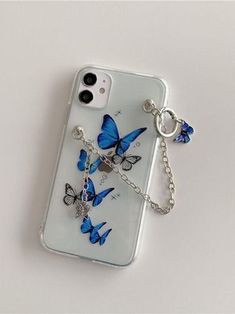 an iphone case with blue butterflies on it and a key chain attached to the back