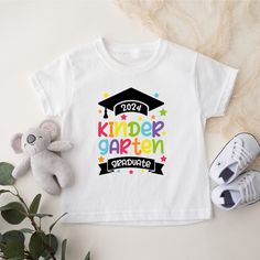 Kindergarten Graduate Shirt, Kindergarten graduation shirt, Kinder Grad 2024, Graduation 2024 Shirt, School Shirt, 2024 Senior Shirt How to Order?  1-Choose your t-shirt color, 2- Choose your size, 3- Select the quantity, 4- Click Add to Cart.  Production and shipping: * 100% airlume combed and ring-spun cotton, 32 singles 4.2 oz. * Solid colors are %100 cotton * Heathers are %52 cotton %48 polyester * Athletic Heather is combed and ring-spun cotton, 10% polyester * Seamless collar * Heat transf Class Shirts Elementary For Kids, Pre K Graduation Shirt Ideas, Pre K Graduation Shirts, Kindergarten T Shirts For Kids, School Graduation T-shirt With Graphic Print, Kids Graduation, Senior Shirts, Kids Class, Preschool Graduation