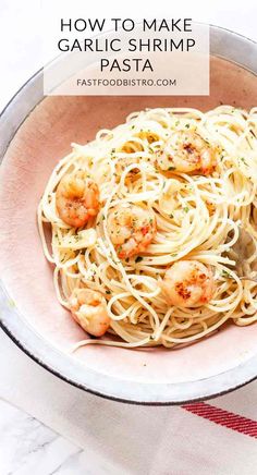 a bowl filled with pasta and shrimp on top of a table