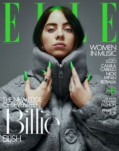 a woman with green nails on the cover of a magazine, wearing a grey coat