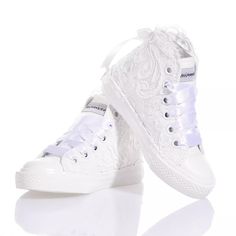 Mimanera Airlines Junior Amabel is inspired by the classic Converse model; these sneakers offer a completely white sole and maximum comfort with every step. Mimanera Airlines Junior Amabel is covered in exquisite embroidered lace with a satin bow at the back, all embellished with a row of Swarovski crystals on the heel and white satin laces. Elegant Lace-up Sneakers With White Sole, White Lace-up Sneakers, Textile Lace-up Sneakers With White Laces, White Sneakers With Lacing And Round Toe, White Sneakers With Round Toe And Lacing, White Round Toe Sneakers With Lacing, Textile Sneakers With White Laces And Round Toe, Elegant White High-top Sneakers, Elegant White Sneakers With Laces