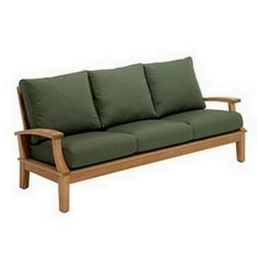 a wooden couch with green cushions on it's back and arm rests against a white background