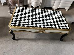 a black and white checkered coffee table with gold trim