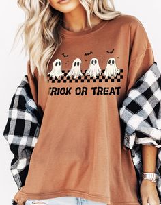 Get ready for Halloween with this adorable "Trick or Treat" Comfort Colors t-shirt featuring a cute ghost design! Perfect for spooky season, this shirt showcases four playful ghosts with a checkered pattern and bats flying above. The vintage-inspired design is printed on a soft, terracotta-colored tee, offering a comfortable, oversized fit. Whether you're heading to a Halloween party or enjoying a cozy night in, this shirt is the ideal choice for all your fall festivities. ★Processing Time: Approx. 1-7 business days (exceptions may occur during holiday seasons). ★Shipping Time: Separate from processing time, approx 2-5 business days. Check estimated delivery times at checkout. Upgrade shipping at checkout if needed sooner. Expedited Shipping: 2-3 business days. ★Shipping Address: Ensure th Spooky Cartoon Print T-shirt For Fall, Fall Spooky Cartoon Print T-shirt, Halloween Long Sleeve Shirt With Funny Print, Spooky Long Sleeve Shirt With Letter Print, Funny Print Long Sleeve Shirt For Halloween, Long Sleeve Shirt With Letter Print In Spooky Style, Cute Halloween Shirt With Graphic Print, Cute Halloween Tops With Letter Print, Cute Halloween Graphic Print Shirt